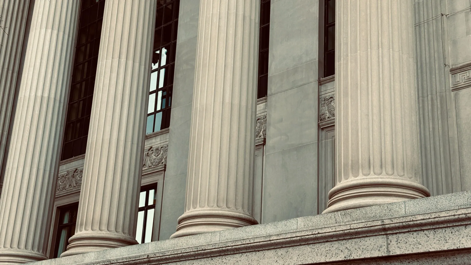 Stone columns on the façade of an institutional building.