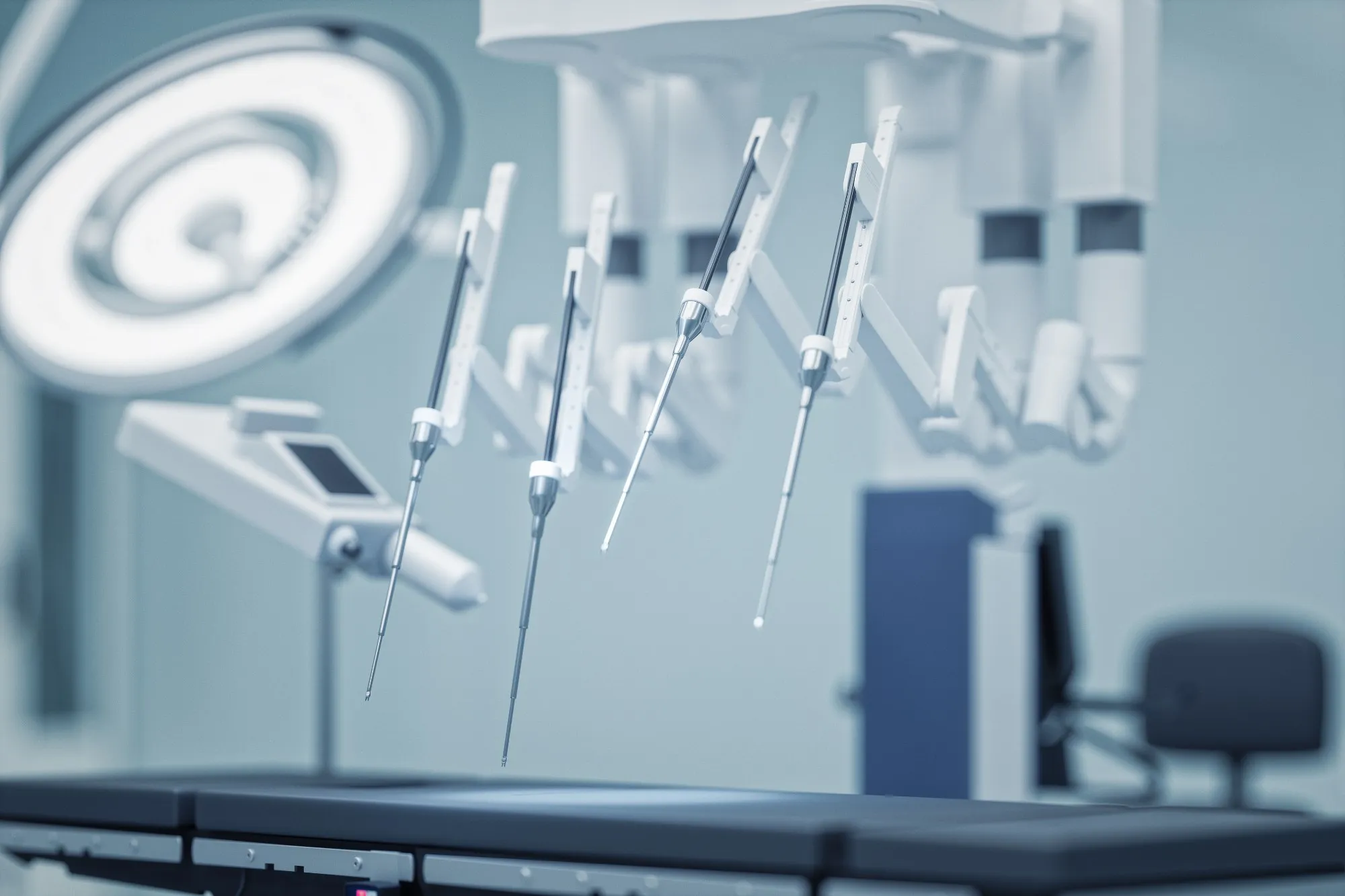 Arms of a surgical robot over an operating table.